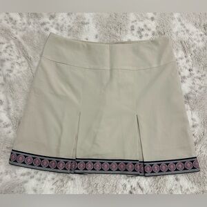 Golftini Brand golf skort, cream with pink and blue trim.  Back pocket, size 4